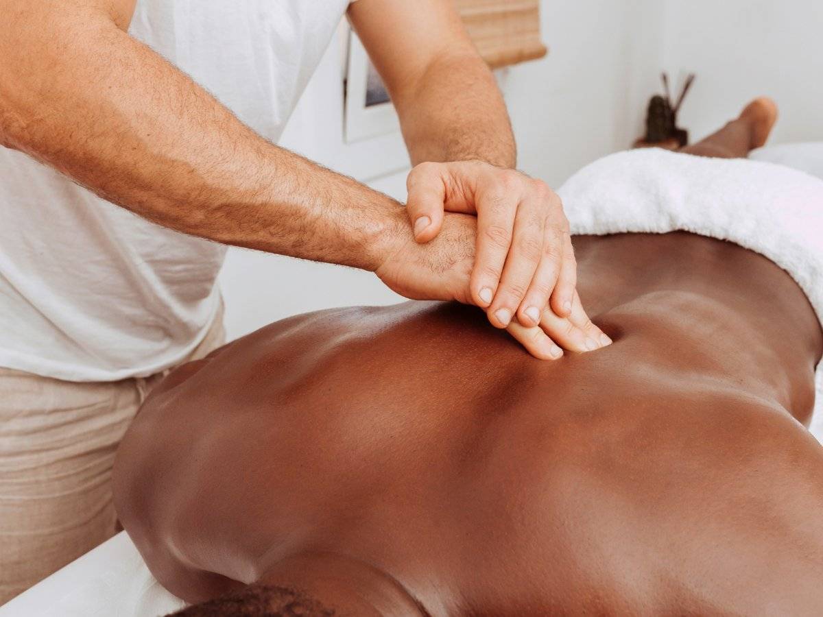 Massage therapist giving a deep tissue massage.